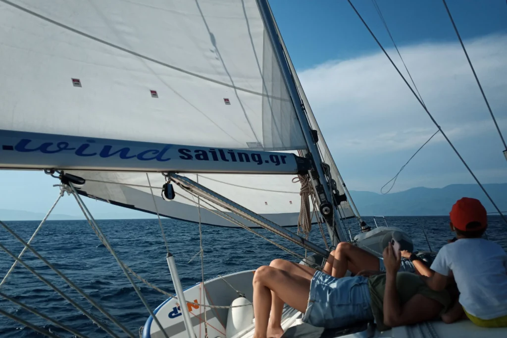 Guests sailing aboard Kyknos yacht with sails up in the Sporades islands
