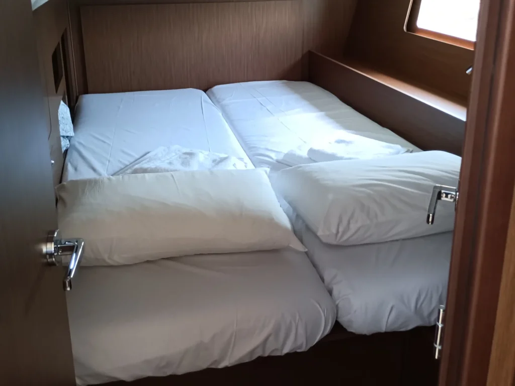 Double bed cabin aboard Zoe sailing yacht with natural light and comfortable sleeping space