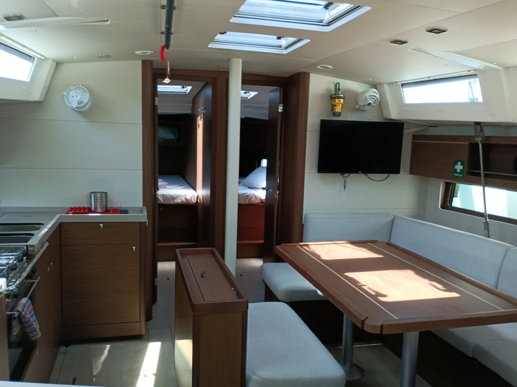 Salon and dining area aboard Zoe sailing yacht with natural light and spacious seating