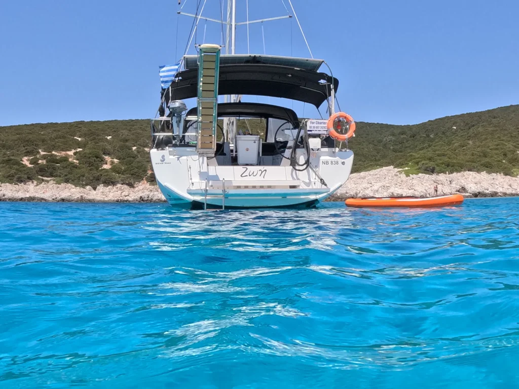 Stern view of Zoe sailing yacht anchored in the turquoise waters of the Sporades, Greece