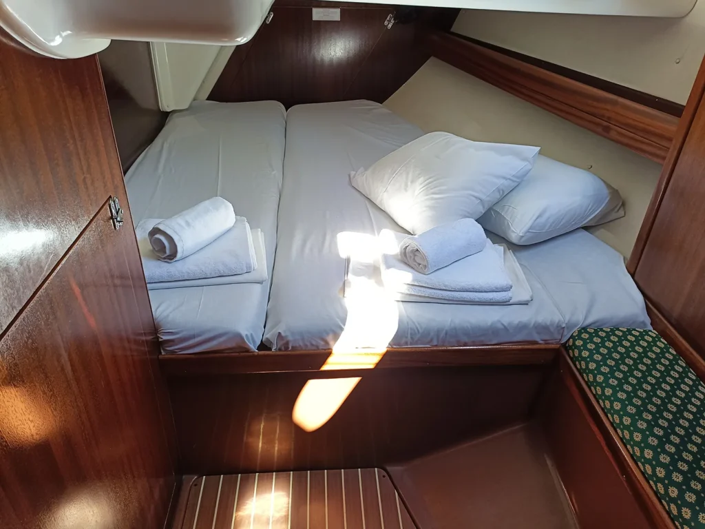 Double bed cabin aboard Kyknos sailing yacht with natural light and comfortable sleeping space