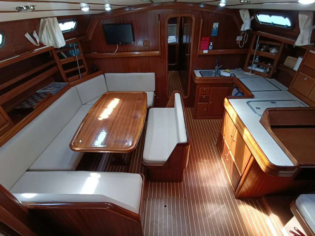 Salon and dining area aboard Kyknos sailing yacht with natural light and spacious seating